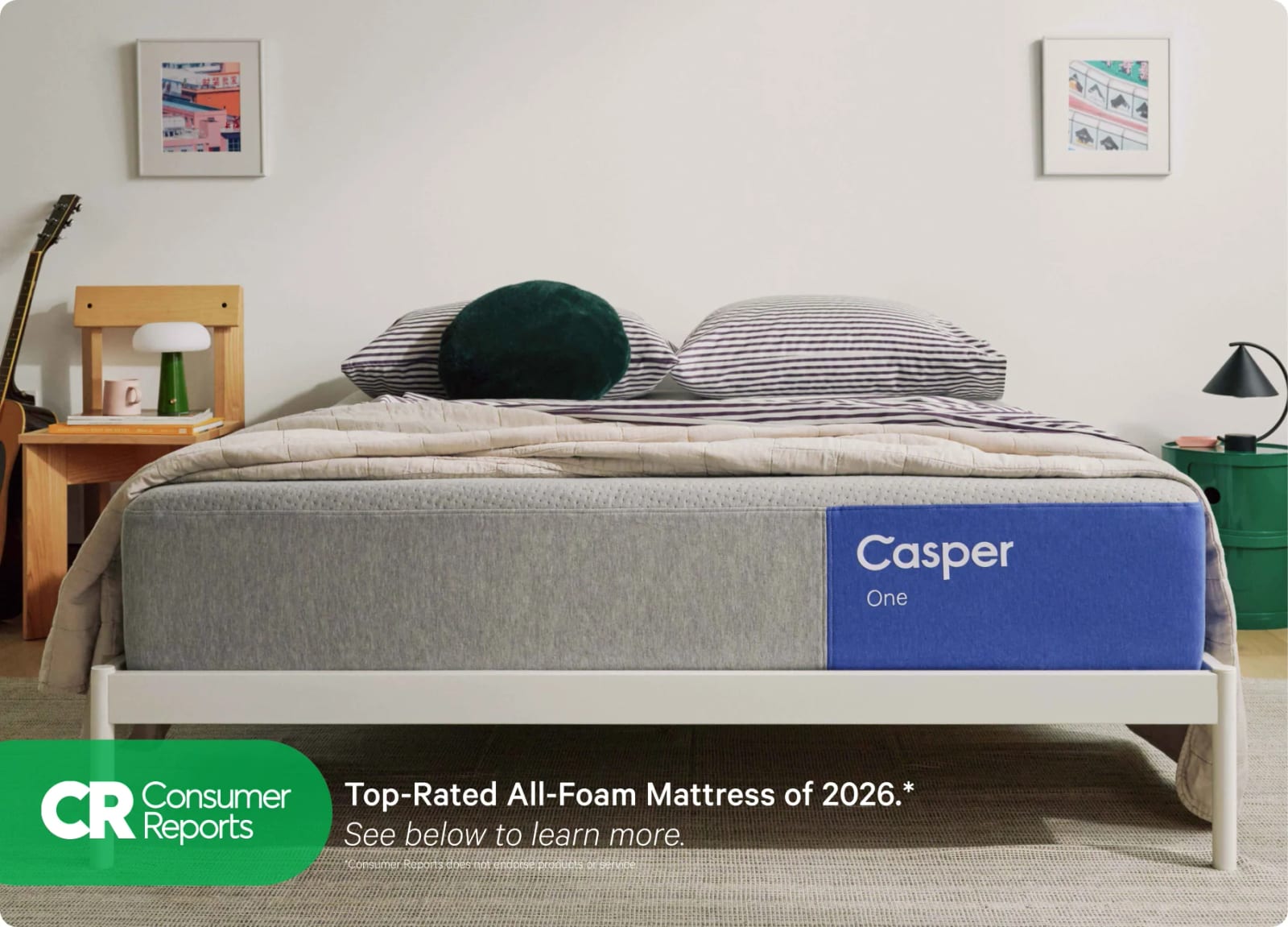 Casper The One all-foam mattress made up on a low wooden platform bed